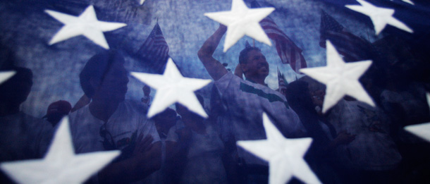 Attendees at a rally for immigration reform are seen through an American flag. (AP/Jae C. Hong)