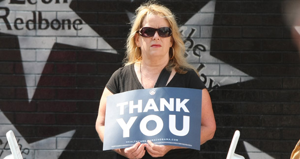 An unidentified woman waits for the presidential motorcade last year near the Target Center in Minneapolis, where President Barack Obama addressed a health care rally. Unmarried women will have better access to health care after the reform bill's passage this week. (AP/David Sherman)