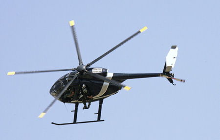 Blackwater security contractors are seen inside a helicopter above central Baghdad, Iraq. (AP/Khalid Mohammed)