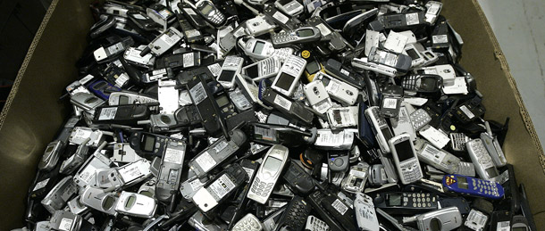 A pile of cell phones is seen at ReCellular in Dexter, MI. Cell phone recycling is on the rise, but the underlying demand for product upgrades continues to drive raw materials consumption and emissions from the industry. (AP/Paul Sancya)