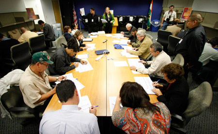 2010 Census job applicants receive instructions on how to fill the application. The federal government added 48,000 jobs last month, many in temporary jobs to conduct the U.S. Census. (AP/Alan Diaz)