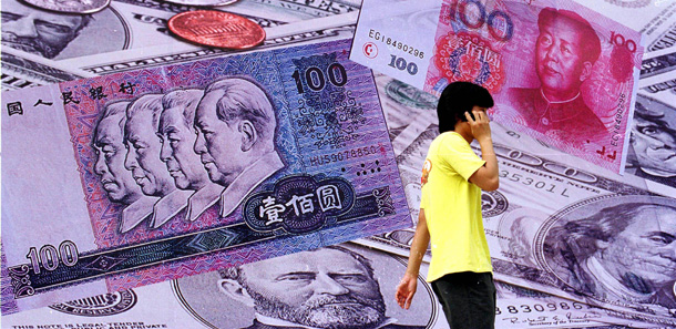 A Chinese man walks past a billboard showing collage of Chinese Yuan and U.S. dollars in Beijing. (AP/EyePress)