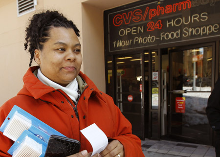 A woman carriers her purchases without a bag as she leaves a CVS Pharmacy in Washington, D.C., February 16, 2010. She put what she couldn't carry in her pockets to avoid the District's 5 cent fee for a plastic bag. (AP/Alex Brandon)
