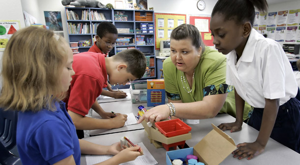 Some schools serving large concentrations of low-income and minority students have dramatically improved student achievement by increasing instructional time. (AP/Chris O'Meara)