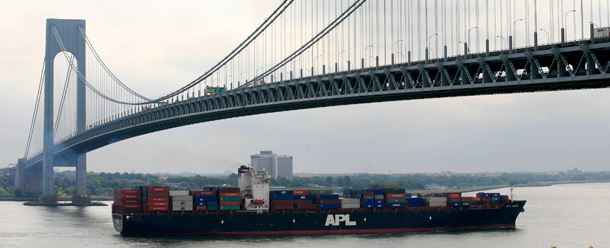 A container ship maneuvers beneath the Verrazano-Narrows Bridge in New York Harbor. Imports are one persistent weakness in U.S. economic growth. (AP/Mark Lennihan)