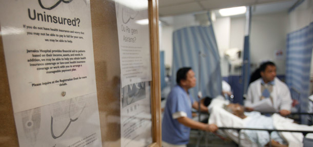 A sign questioning patients about their medical insurance is posted in the emergency room of Jamaica Hospital in New York. (AP/Seth Wenig)