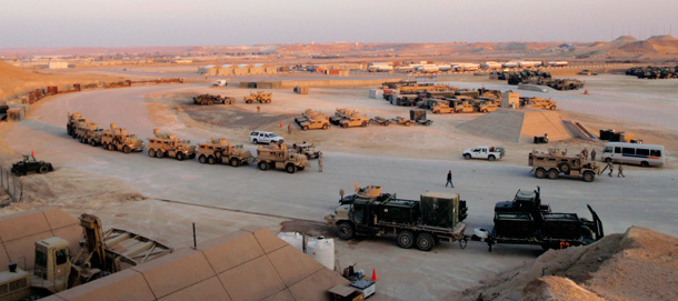 Trucks and containers of military equipment wait to be shipped out from a Marine base outside al-Asad in Iraq's western Anbar province to troops in Afghanistan as part of the U.S. redeployment form Iraq. (AP/Lara Jakes)