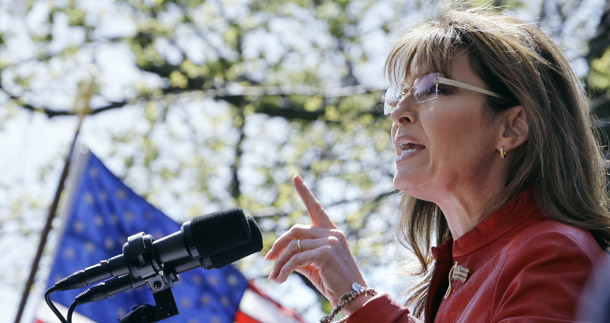 Sarah Palin gestures while addressing a crowd during a stop of the Tea Party Express, April 14, 2010, on the Boston Common in Boston. Palin is on her way to making $20 million this year alone through her various television, book, speaking, and other self-promotional products. (AP/Charles Krupa)