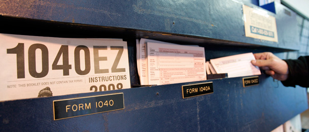 A man picks up federal tax forms at a post office in Palo Alto, California. (AP/Paul Sakuma)