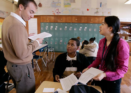 A sophomore at Boston Community Leadership Academy pilot high school receives attention from his math and English teachers during an advisory period. (AP/Stephan Savoia)