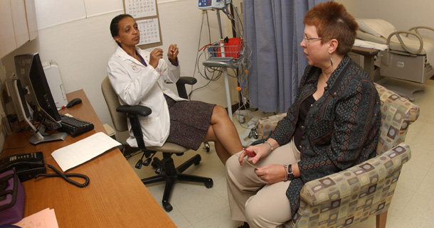 Well Women Clinic's Dr. Bethesaida Tafari Habte discusses health care with U.S. Air Force veteran Wendy Haylor of  Piedmont, WV. Despite statements from groups such as the Veterans of Foreign Wars and some Republican congressmen, health care reform will not negatively affect TRICARE. (AP /Ron Agnir)