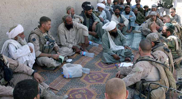 Village elders, Afghan army officers, and U.S. Marines take part in a shura meeting to discuss damage done during a raid in August 2009. The United States has heavily focused on military operations in Afghanistan and neglected state building. (AP/Alfred De Montesquiou)