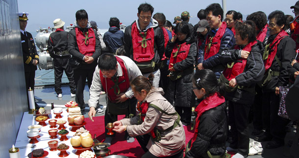 Family members of deceased sailors from the sunken South Korean naval ship Cheonan participate in a memorial service aboard a naval ship on Baengnyeong Island, South Korea, on April 30, 2010. An international investigation found overwhelming evidence this week that North Korea was to blame for sinking the ship.
  (AP/South Korea Navy via Yonhap)