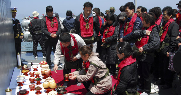 Family members of deceased sailors from the sunken South Korean naval ship Cheonan participate in a memorial service aboard a naval ship on Baengnyeong Island, South Korea, on April 30, 2010. An international investigation found overwhelming evidence this week that North Korea was to blame for sinking the ship.
(AP/South Korea Navy via Yonhap)