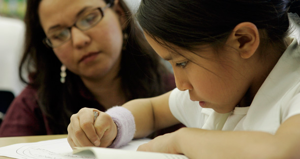 A fourth-grade teacher teacher instructs a student at the at the Dean L. Shively School in South El Monte, California. (AP/Ric Francis)