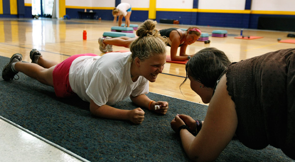 Cayla Giaimo, left, and Melenda Campbell, right, working out with  instructor Jenn Hall, center, during an aerobics class at Wellsprings,  FL. While planning your routine to achieve those killer glutes and abs, don’t forget about the effect your workout has on the environment. (AP/Chris O'Meara)