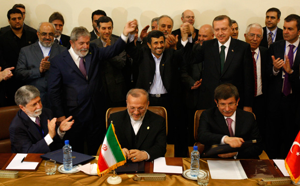 Iranian President Mahmoud Ahmadinejad, center, joins hands with his Brazilian counterpart Luis Inacio Lula da Silva and Turkish Prime Minister Recep Tayyip Erdogan on May 17 after signing an agreement to ship most of Iran's enriched uranium to Turkey in a nuclear fuel swap deal. (AP/Vahid Salemi)