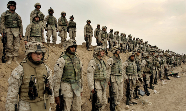 U.S Marines of the 1st Division line up for a joined prayer at their base outside Fallujah, Iraq. When weighing possible benefits against the costs of the Iraq intervention, there is simply no conceivable calculus by which Operation Iraq Freedom can be judged to have been a successful or worthwhile policy. (AP/Anja Niedringhaus)
