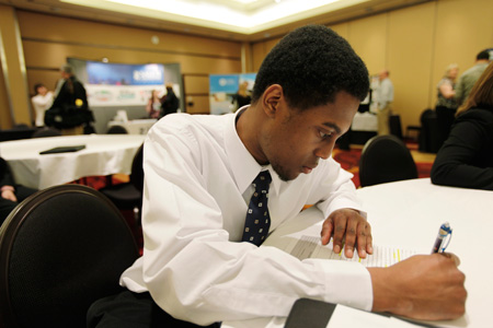 A job seeker fills out an employment application during a job fair in Tacoma, Washington. (AP/Ted S. Warren)