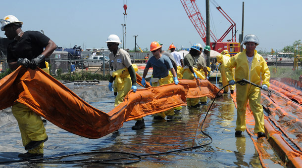 Workers at a decontamination site in Venice, LA, carry an oil containment boom that was used to clean up the spill on May 4, 2010. Many organizations are calling for volunteers to help in the clean-up effort. (AP/U.S. Coast Guard, Petty Officer 3rd Class Patrick Kelley)