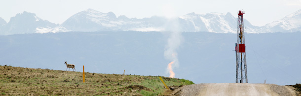 An antelope passes by a natural gas drilling rig just south of Pinedale, Wyoming where energy development has progressed on such a broad and intensive scale that it gas transformed the quiet rural area into an industrial zone with air pollution problems more commonly found in Los Angeles. (AP/Douglas C. Pizac)