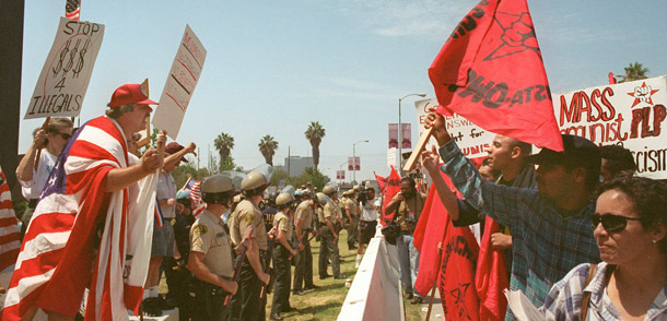 Pro- and anti-Proposition 187 activists are separated by a police line during a rally outside the Federal Building in the Westwood section of Los Angeles on August 10, 1996. (AP/Frank Wiese)