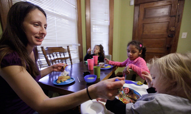 Lisa Zilligen, a single mother and full-time student at Chicago's Loyola University, serves lunch to her three children, Miles, 20 months, Olivia 6, left, and Danielle, 8. Asset tests aren’t just a burden on families; they also incur unnecessary administrative costs to state agencies that handle the disbursement of TANF benefits. (AP/M. Spencer Green)