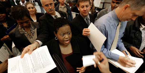 Job seekers hand over resumes at a job fair in Livonia, Michigan. (AP/Paul Sancya)