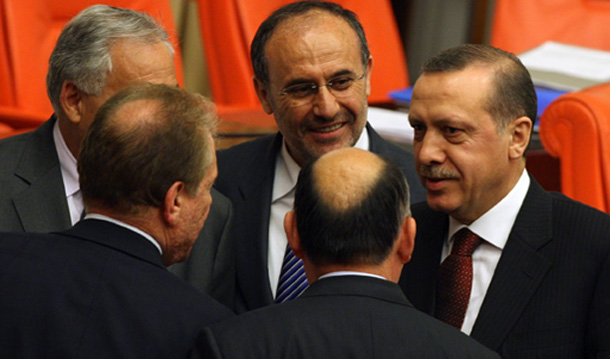 Turkish Prime Minister Recep Tayyip Erdogan, right, speaks with his  party members at the Parliament on April 20, 2010. Solving the minority questions and defining citizenship in a way that  embraces cultural and religious diversity will enhance Turkey's role as a model for its Eastern neighbors. (AP/Burhan Ozbilici)