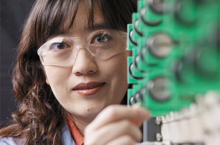 A scientist at Pacific Northwest National Laboratory displays materials and batteries that the reserachers have been developing for stationary energy storage applications. (Flickr/PNNL)