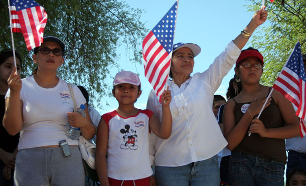 Four women hold flags at a peaceful demonstration in Arizona protesting the government's treatment of immigration reform. (AP/Roy Dabner)