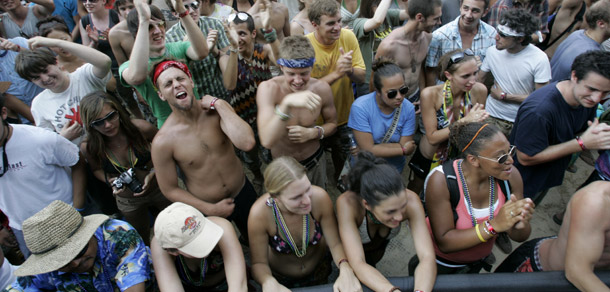 Fans cheer at the Bonnaroo music festival in Manchester, TN. Bands and their fans are making efforts to make concerts and festivals more sustainable. (AP/Mark Humphrey)