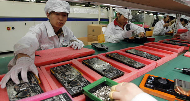 Workers on the production line at the Foxconn complex in Shenzhen, China, which drew attention to labor conditions in the country after a string of suicides this year. (AP/Kin Cheung)