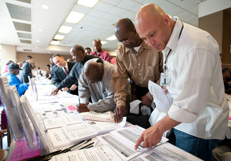 Eduardo Mendoza looks over job ads during the ninth annual Skid Row Career Fair at Los Angeles Mission in Los Angeles. (AP/Adam Lau)