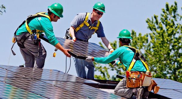 Solar City employees install a solar panel on a home in south Denver. (AP/Ed Andrieski)