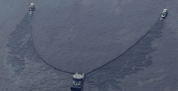 Vessels collect oil near the site of the Deepwater Horizon oil spill in the Gulf of Mexico on May 17, 2010. Americans are intently focused on the BP disaster and overwhelmingly favor solutions to reduce oil use. (AP/Charlie Riedel)