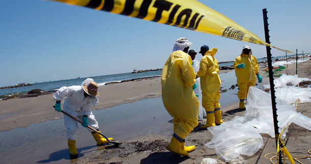 Workers collect oil that has washed ashore on Fourchon Beach Port Fourchon, Louisiana. (AP/Patrick Semansky)