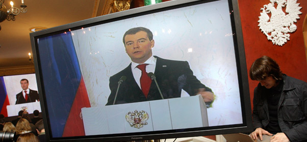 TV sets broadcast Russian President Dmitry Medvedev's address to the nation at the next hall in the Moscow Kremlin on November 12, 2009, where he said Russia needs to shed its dependence on exports of raw materials and build a new high-tech economy to survive. (AP/Sergei Ponomarev)