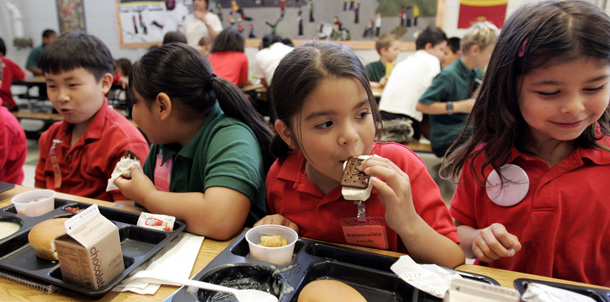 Elementary school students eat lunch at school in Minnesota, but when school is out ifor the summer, some of them may have trouble getting the meals they need. (AP/Eric Miller)