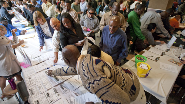 Job seekers gather at a career fair on June 3, 2010, in Los Angeles. Unemployment insurance is the primary mechanism to provide financial assistance to workers who are unemployed through no fault of their own. (AP/Adam Lau)