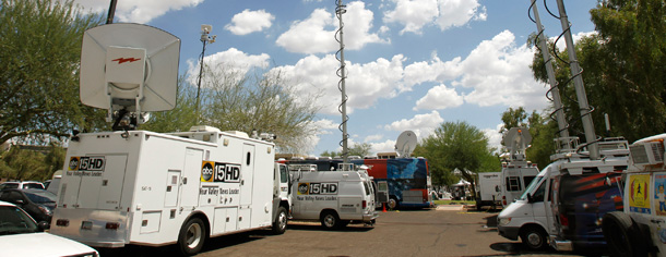 Television satellite trucks gather at the Arizona capitol on July 28, 2010 in Phoenix shortly after a federal judge blocked portions of Arizona's controversial new immigration law, SB1070. (AP/Ross D. Franklin)