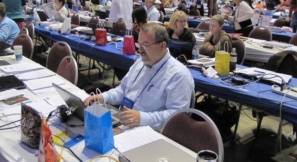 A man checks his laptop before the afternoon session of the Presbyterian Church's General Assembly on July 8, 2010. At the assembly, representatives voted to voted to allow ordination of LGBT church leaders, extend benefits to same-sex partners of church staff, and increase education and awareness regarding HIV-AIDS. (Flickr/<a href=