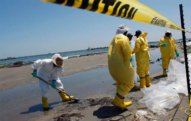 Workers clean up the gulf shore. The BP disaster reiterates why we need to better manage the short- and long-term responses required to address the public health threats such disasters pose whether they are manmade or due to natural causes. (AP/Patrick Semansky)