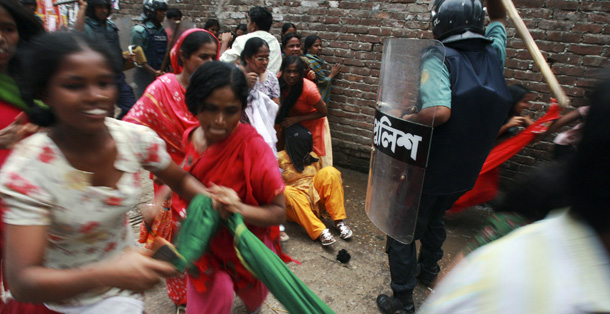 Bangladeshi police use batons to disperse protesters in Dhaka, Bangladesh on July 30, 2010. Thousands of garment workers rampaged through central Dhaka and clashed with police to protest what they consider an inadequate increase in the minimum wage rate. (AP/Pavel Rahman)