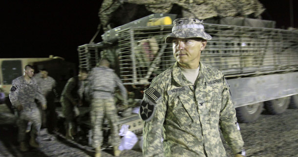 U.S. Army Col. John Norris, commander of the 4th Stryker Brigade Combat Team, 2nd Infantry Division, waits for the last Stryker armored vehicle carrying his soldiers to arrive after crossing into Kuwait from Iraq on August 19, 2010. (AP/Maya Alleruzzo)