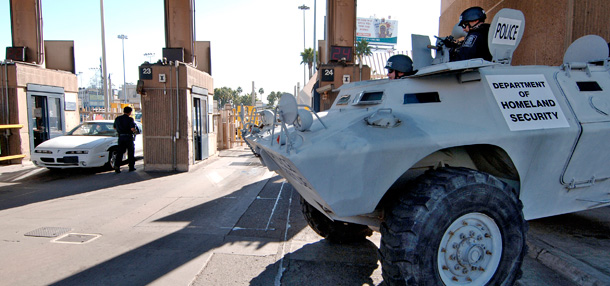 U.S. Immigration and Customs Enforcement agents in an armored personnel carrier watch traffic entering the United States from Mexico. (Ap/Denis Poroy)