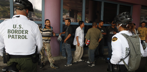 A group of illegal immigrants wait in line while being deported to Mexico at the Nogales Port of Entry in Nogales, AZ. Many immigrants don't even make it this far, however, as many suffer crimes and unnecessary death daily while attempting to cross the border illegally. (AP/Jae C. Hong)