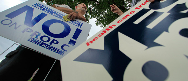 Missouri voters for and against Proposition C—a ballot measure in Missouri to block the federal health insurance law—debate during a rally in Kansas City, Missouri. (AP/Charlie Riedel)