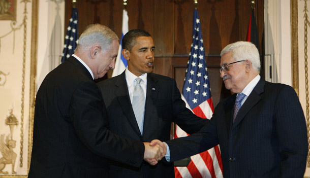 President Barack Obama watches as Israeli Prime Minister Benjamin Netanyahu and Palestinian President Mahmoud Abbas shake hands, September 22, 2009, in New York. Direct talks between Israel and Palestine will begin this week, and the president will also give a speech on Iraq on Tuesday. (AP/Charles Dharapak)