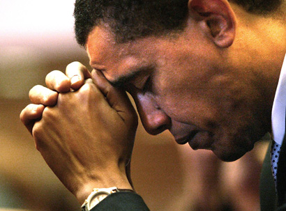 President Obama prays during a service at Trinity United Church of Christ in Chicago. (AP/Nam Y. Huh)